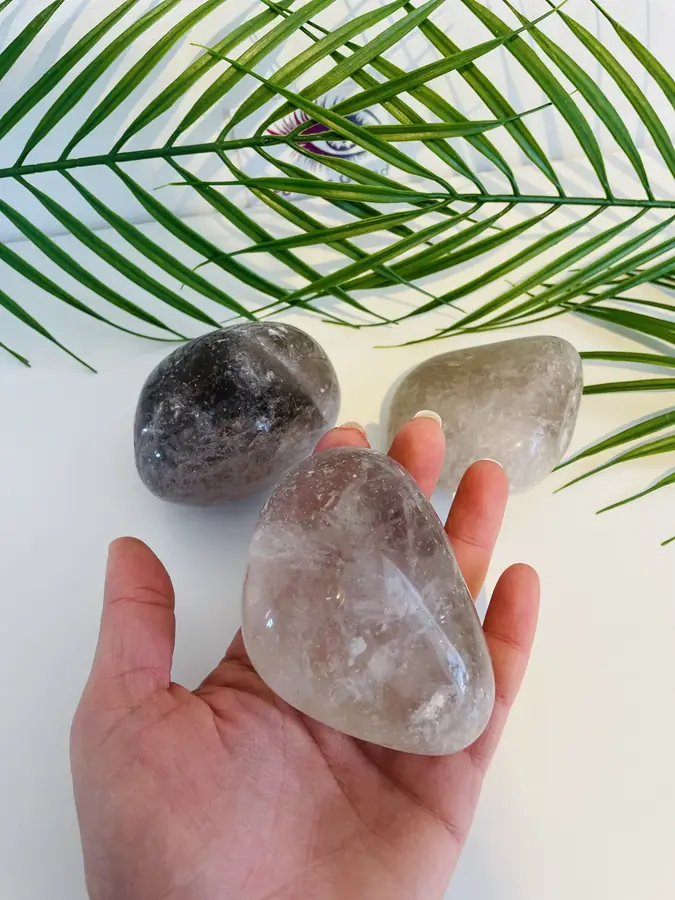 Smokey quartz pebble, held in the hand