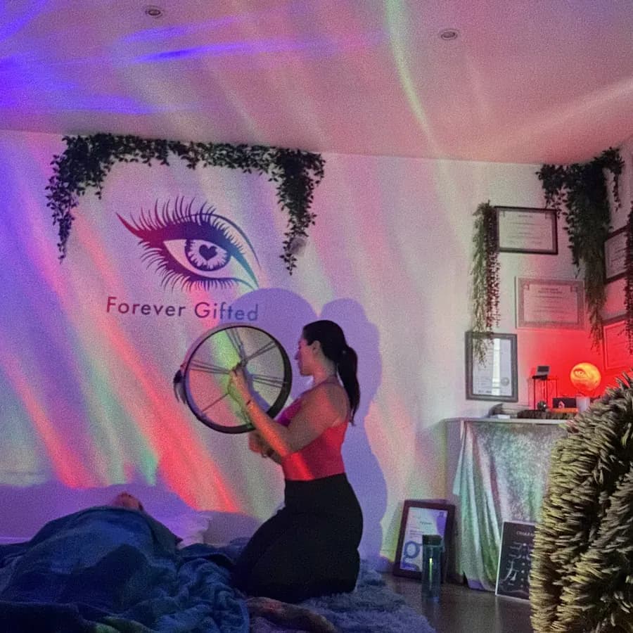 The cabin at night, aurora light across the eye on the wall as Filiz drums